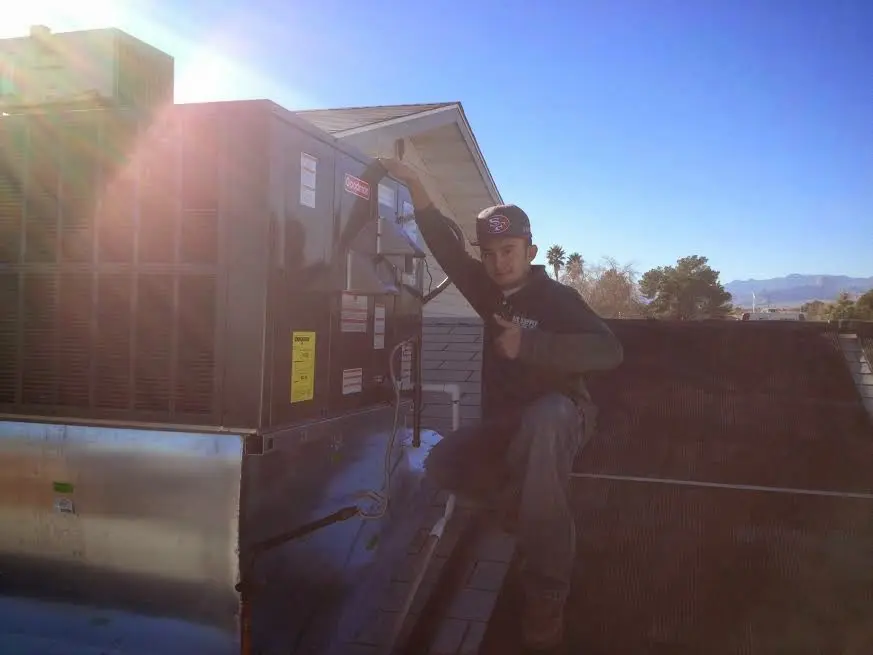 HVAC technician performing HVAC Inspection on a rooftop unit in Cloverleaf